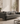 Gray sofa with decorative pillows in a living room setting, featuring the brand 'Moham Furnishers'.