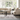 A modern beige fabric upholstered sofa set with wooden legs, plush cushions, and sleek armrests in a well-lit living room setting.