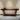 A modern minimalist design ND Console Table with angular legs made by Mohkam Furnishers, placed against a wall with a polished wood surface and a subtle drawer.