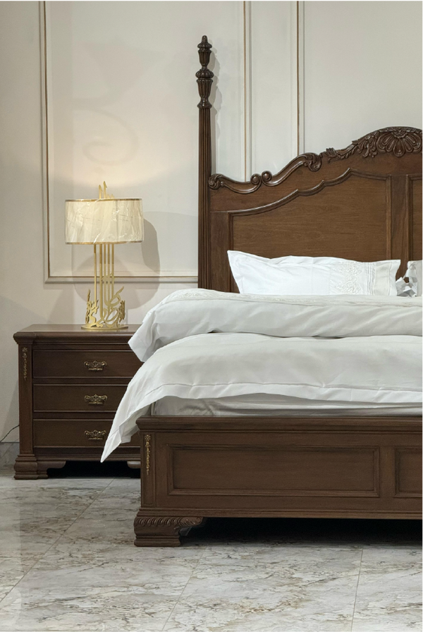 Wooden bed with white bedding and a matching nightstand in a bedroom setting.