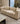 Beige sofa with decorative pillows in a stylish living room setting, featuring the brand 'Mohkam'.