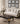 Living room with a white sofa, black coffee table, and decorative pillows, featuring Mohkam Furnishers branding.