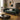Green sofa in a living room with a coffee table and decorative items.