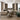 Modern living room with beige sectional sofa, green ottoman, and decorative elements.