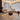 Modern living room with a beige sectional sofa, coffee table, and decorative items.