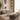 Modern living room with gray tufted sofas, a coffee table, and decorative elements.