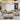 Modern living room with a beige sectional sofa, ottomans, and decorative pillows.