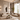 Modern living room with beige sofas, a coffee table, and decorative elements.